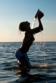 beautiful young girl has a shower bath in sea