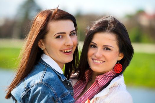 Young and attractive girlfriends have fun in park 