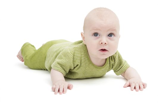 crawling baby in green romper suit isolated on white background. studio shot