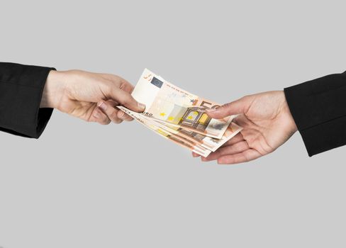 Concept image of hands making and receiving a payment, isolated over a gray background