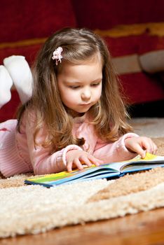 sweet  little girl reading book 