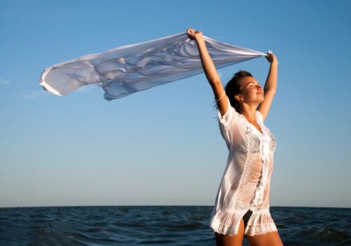 Girl with kerchief on the sunset. Relax scene 