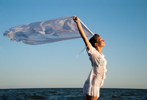 Girl with kerchief on the sunset. Relax scene