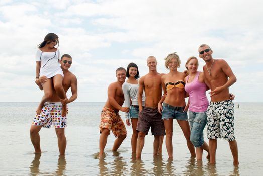 Group of friends having fun at the sea 