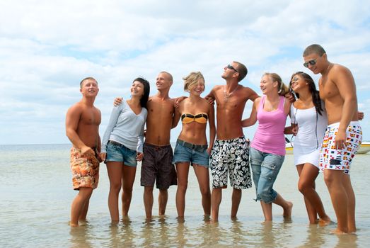 Group of friends having fun at the sea