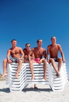 Group of friends having fun at the beach 