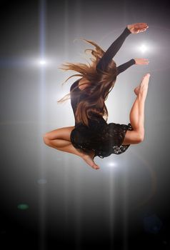 stylish and young modern style dancer jumping in studio 