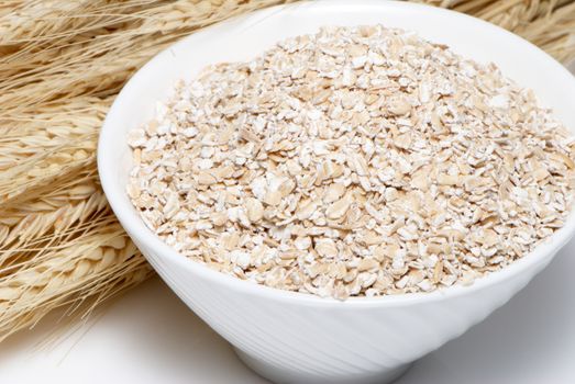 Porridge and Wheat ears on a white background