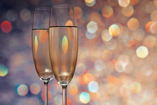 Glasses with champagne on an abstract background