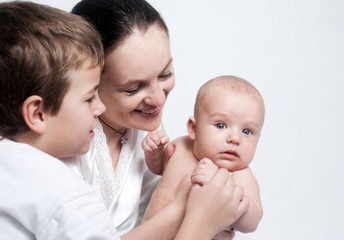 Portrait baby with happy family on light background 