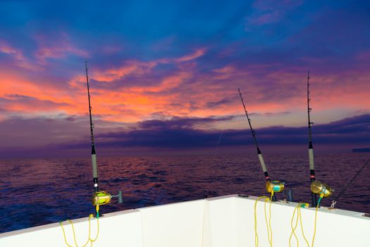 boat fishing trolling at sunset big game with rods and reels in saltwater