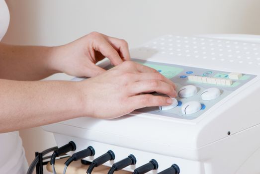 Hands of masseur on massage device