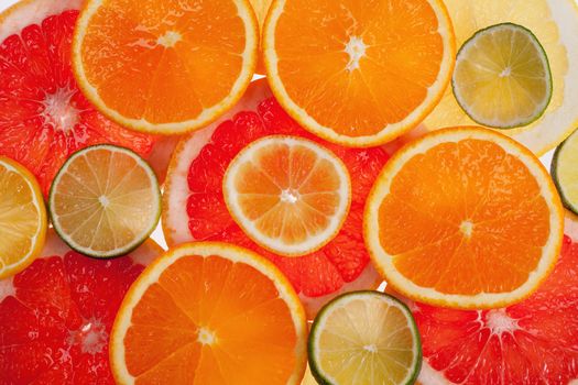 background of different colored slices of citrus fruits close up
