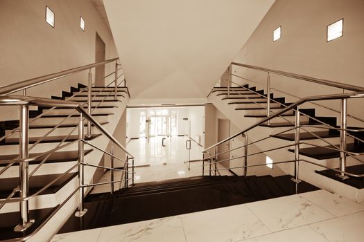 Glass doors with a kind on a marble staircase