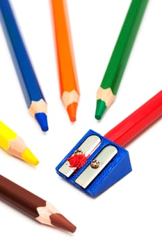 colored pencils and sharpener on a white background