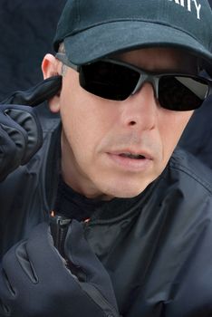 Close-up of a close protection officer reporting.