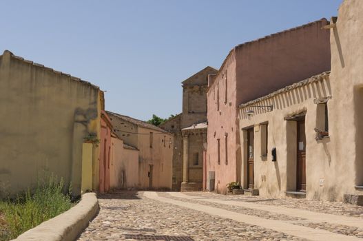 Narrow street of a small village that leads to the Romanesque church