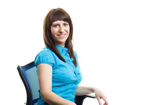 Smiling confident attractive girl sitting on a chair against white background