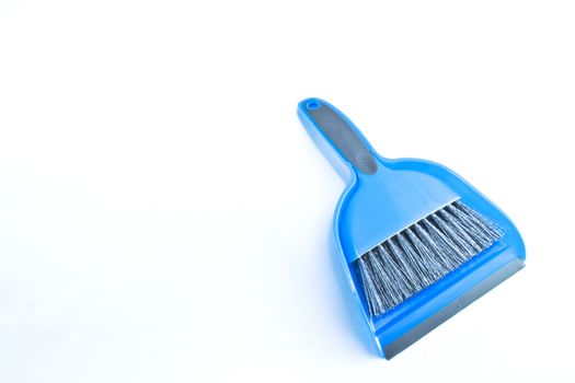 Clean shot of a blue plastic hand broom and rubber-edged dust pan. Gray bristles and accent colors.