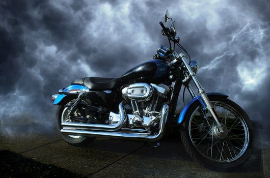 Riderless motorcycle. Clean, shiny, sparkling paint and chrome. Dynamic storm cloud background.