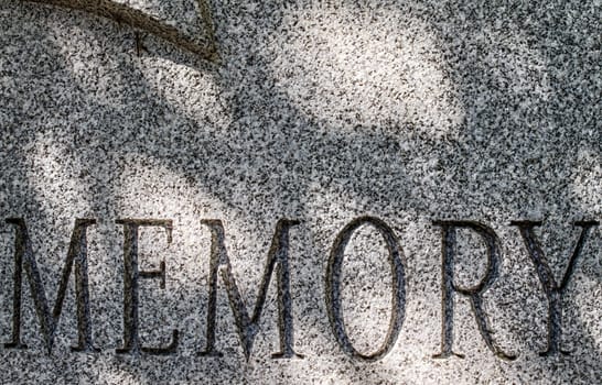 The word memory etched into granite.