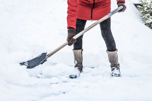 Close-up of Woman Shoveling her Parking lot after Snowstorm