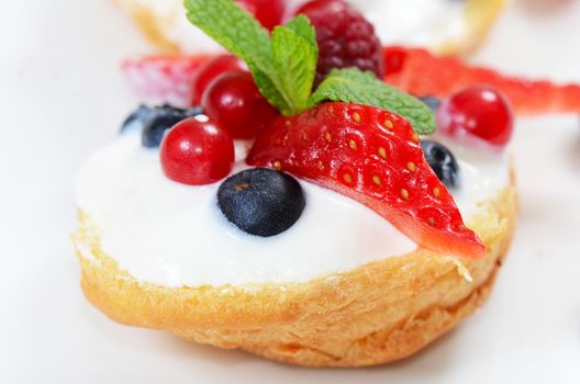 Profiteroles with berries currant  strawberries and blueberries