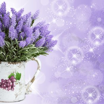 Jug with wild flowers on lilac background