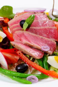 Nicoise with fresh tuna and vegetables close-up