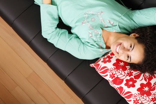 A jung brazilian woman relaxing on the sofa.