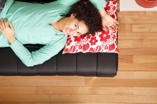 A jung brazilian woman sleeping on the sofa.