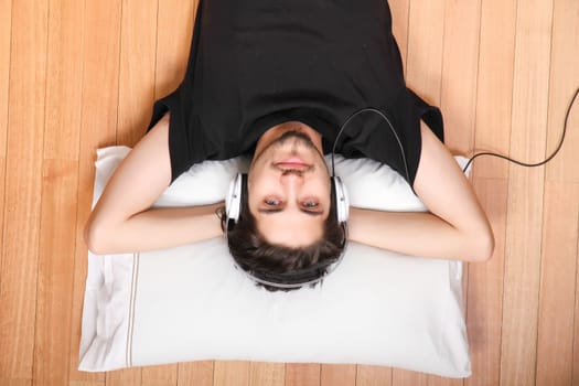 A young hispanic man listening Music with headphones.