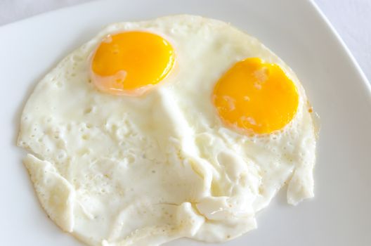 Two fried eggs placed in the dish.