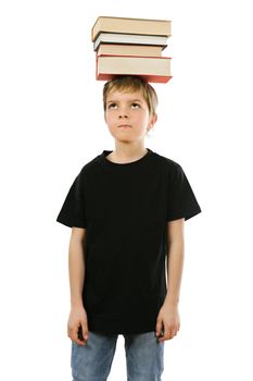 Young boy with blank black t-shirt balancing books on his head. Ready for your design or artwork.