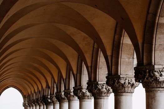 Photo of a row of arches and columns in Piazza San Marco in Venice Italy.