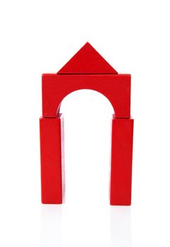 House made out of red wooden building blocks over white background