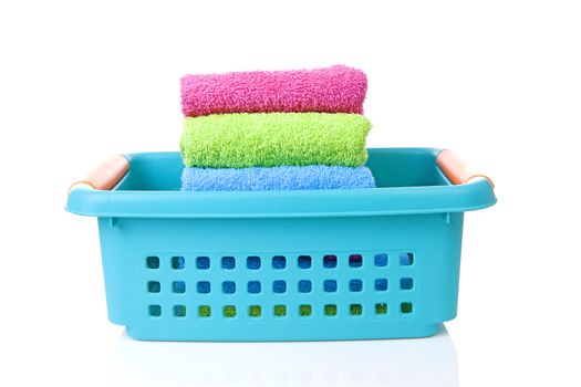 Blue basket made of plastic with laundry over white background