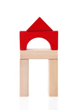 House made out of wooden building blocks over white background