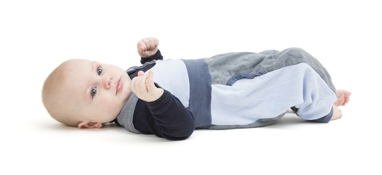 baby boy laying on floor. neutral grey background. studio shot