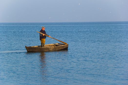 fisherman in boat on water