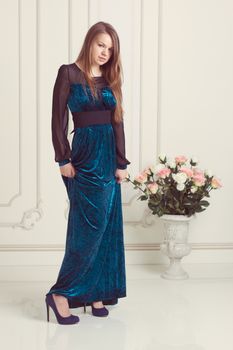 Beautiful blonde woman in a evening long dress.