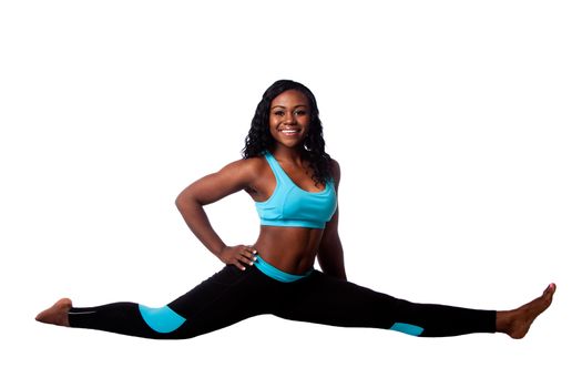 Happy smiling woman sitting in gymnastics leg split, isolated.