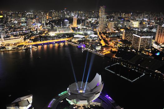 ArtScience museum iluminated in front of Singapore downtown. View from Marina Bay Hotel