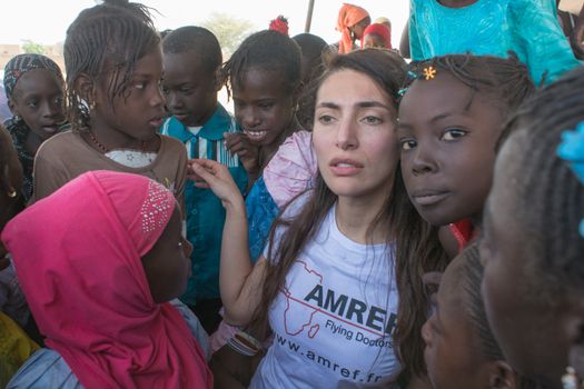 MATAM,SENEGAL-CIRCA NOVEMBER 2013:Actress Caterina Murino greets the children of an elementary school,Caterina Murino is the testimonial of the NGO AMREF,circa November 2013.