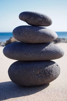 Stones pyramid at the seaside, sunny day