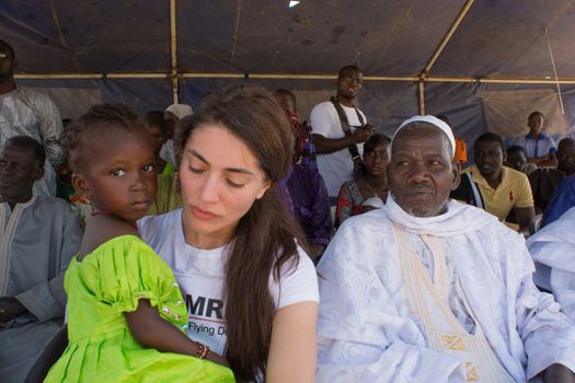 MATAM,SENEGAL-CIRCA NOVEMBER 2013:Caterina Murino with an African child in her arms. Participate with the authorities at a school production,she is the testimonial of the NGO AMREF,circa November 2013.