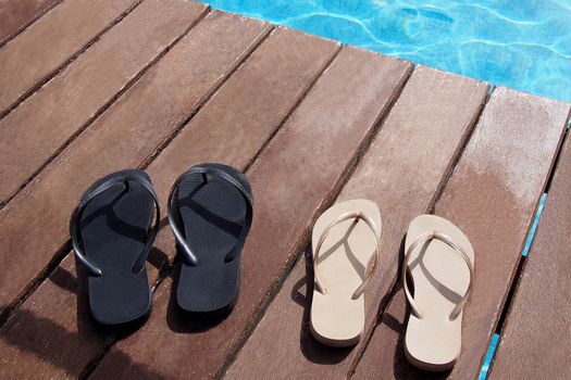 Flip flops at swimming pool from the family