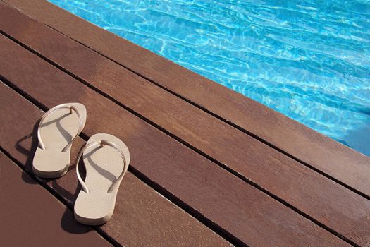 Men's flip-flops by the swimming pool