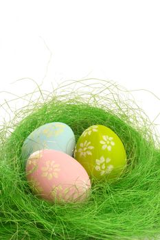Easter eggs in hay nest isolated on white background