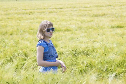 young girl in the field of barley